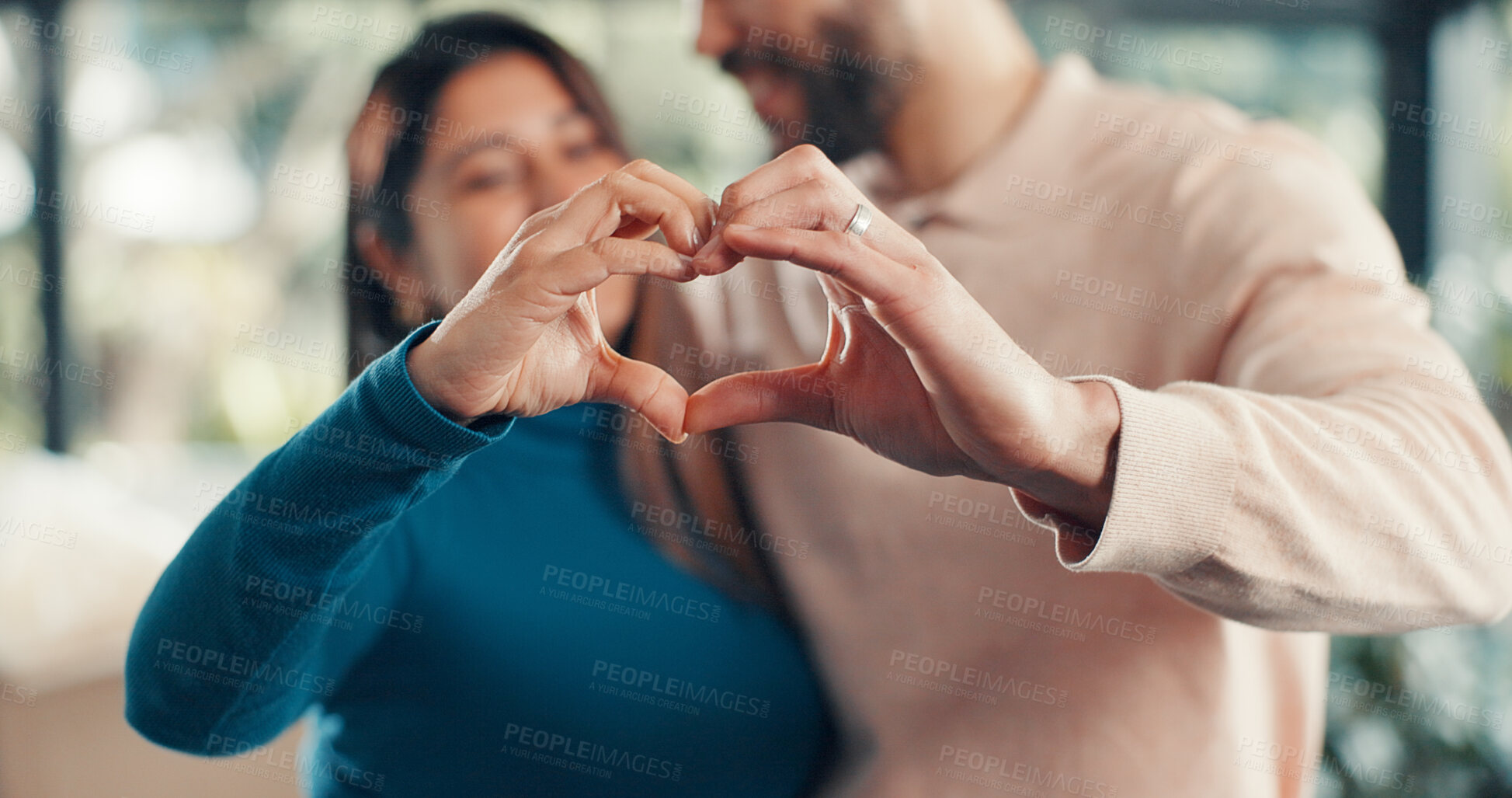 Buy stock photo Couple, heart hands and sign at new home, moving and property sale with relocation for fresh start. People, partnership and symbol with love, celebration and support for achievement at apartment