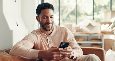 Buy stock photo Smile, texting and man in home with mobile, doom scrolling and funny chat on app. Digital, meme and Asian male in living room with tech, virtual game or online communication in message update.