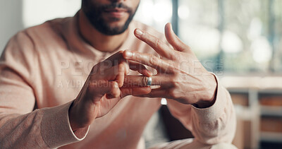 Buy stock photo Unhappy, hands and man in home with wedding ring, divorce or issue in marriage affair. Conflict, trust and married male in living room with union band, reflection or decision of legal separation.