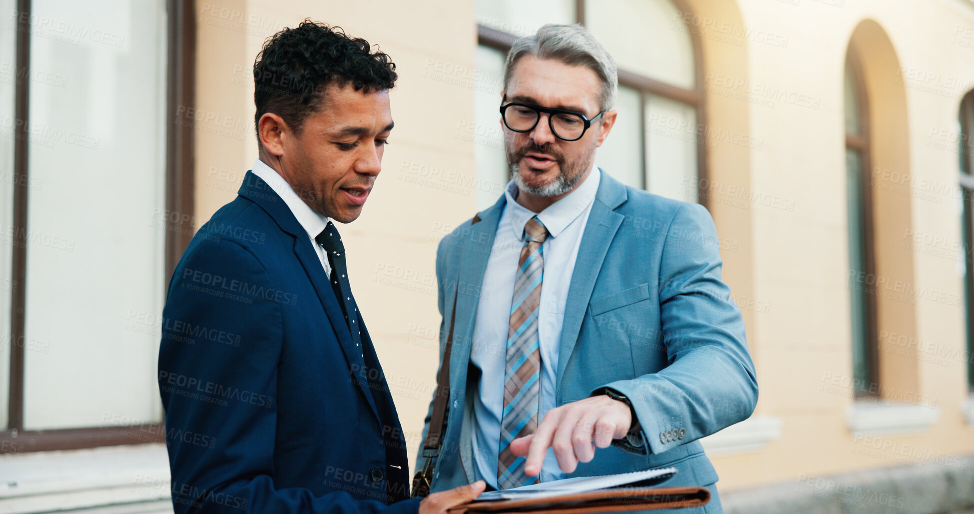 Buy stock photo Collaboration, consulting and legal documents with lawyer men outdoor in city for trial planning. Advice, conversation and pointing with advocate team reading case paperwork or evidence downtown