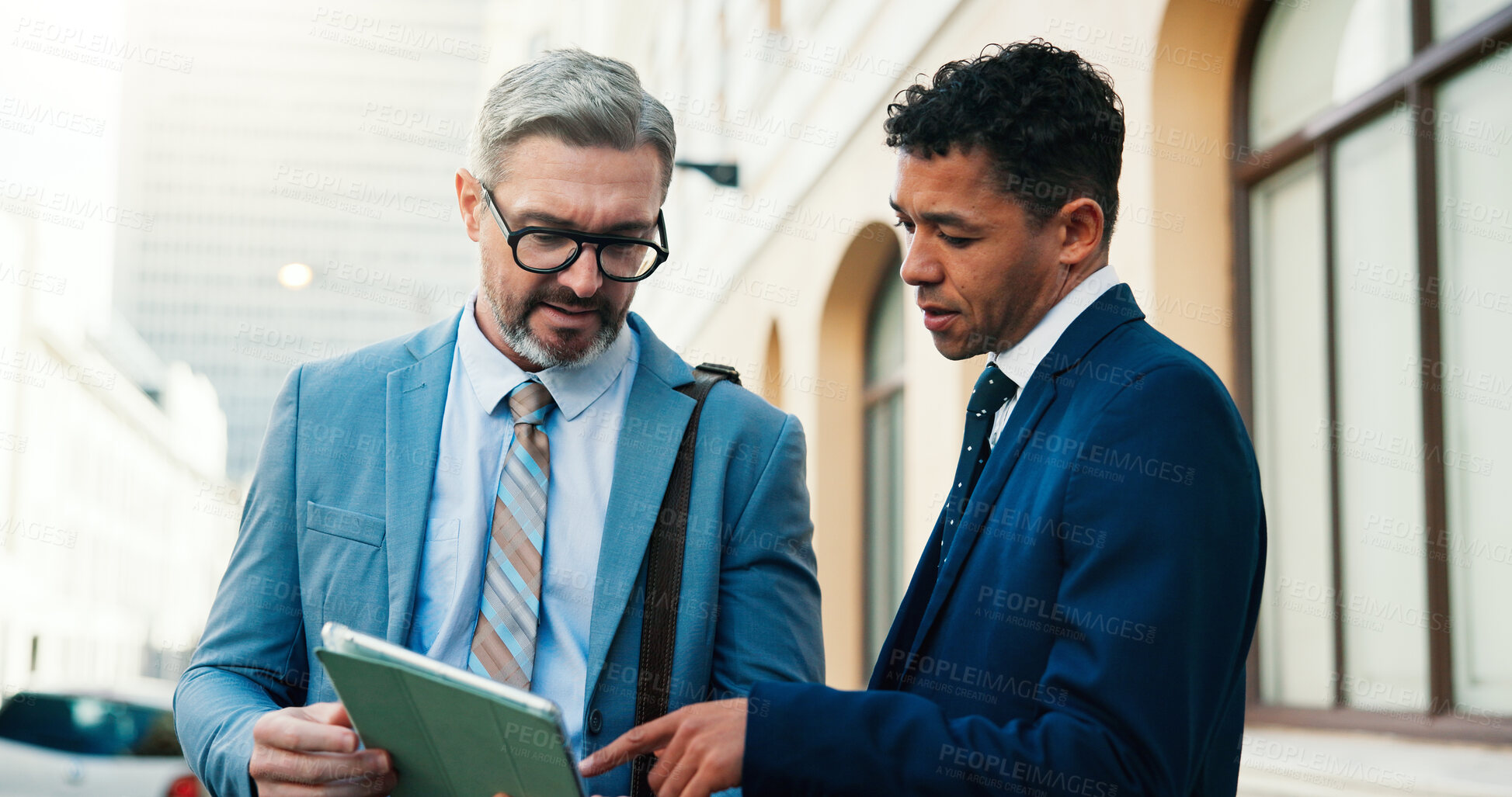 Buy stock photo Lawyers, men and tablet outdoor with discussion for court preparation, litigation or legislation online. Review case notes, team or people in city with tech, trial meeting or ready for legal hearing