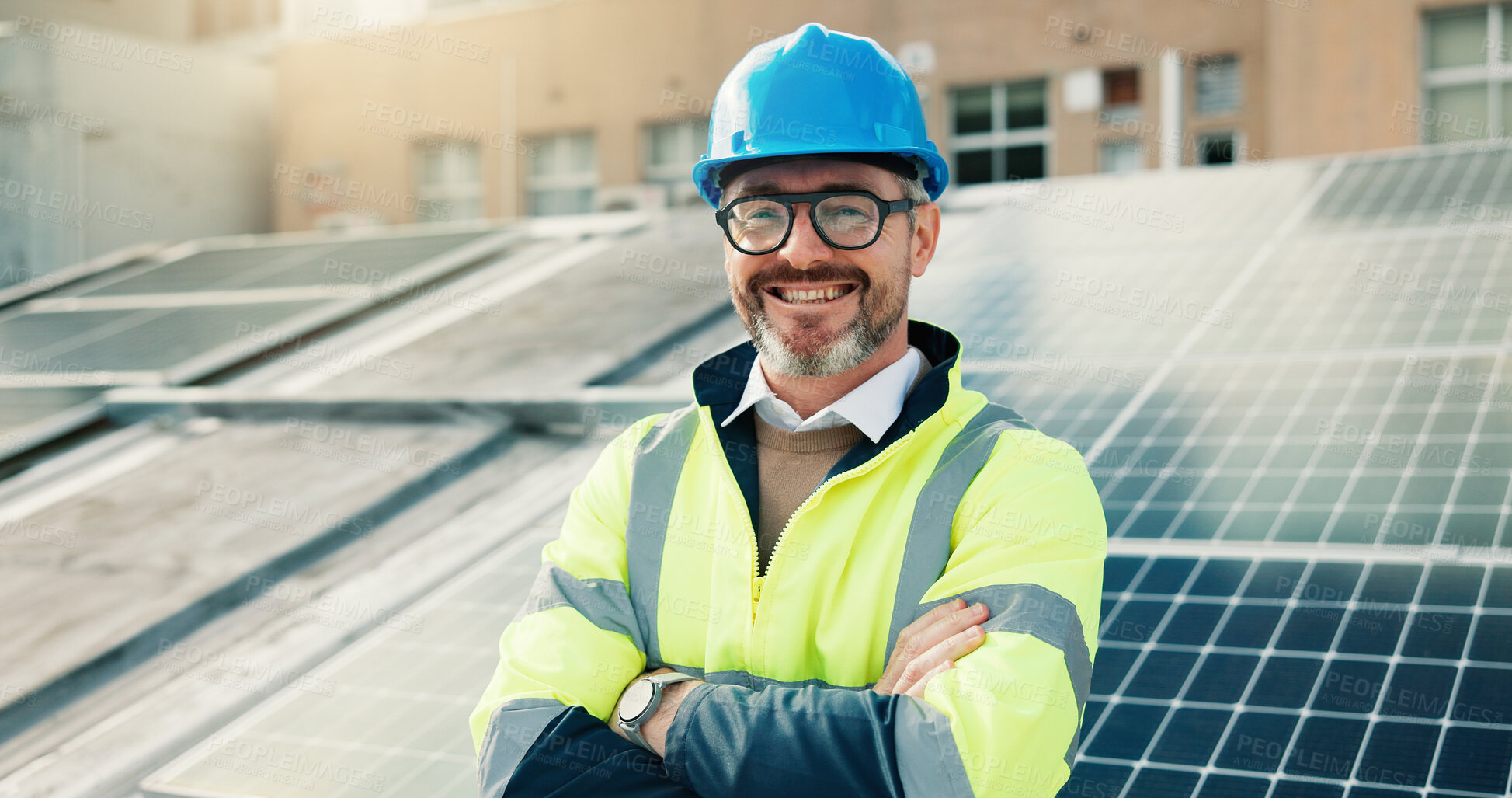 Buy stock photo Solar panel, happy man and portrait of engineer with arms crossed on roof in city. Photovoltaic electrician, confident and mature technician with renewable power, sustainable and clean energy outdoor