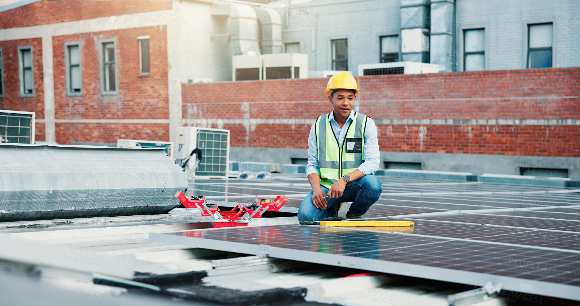 Buy stock photo Industry, solar panels and worker on rooftop outdoor for PV installation, repairs or maintenance. City, photovoltaic cells and male technician for renewable energy project with site inspection.