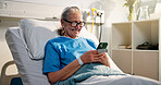 Senior woman, phone and happy in hospital bed with texting, notification or get well soon message. Person, smartphone and web chat on social media with rehabilitation, health or wellness at clinic