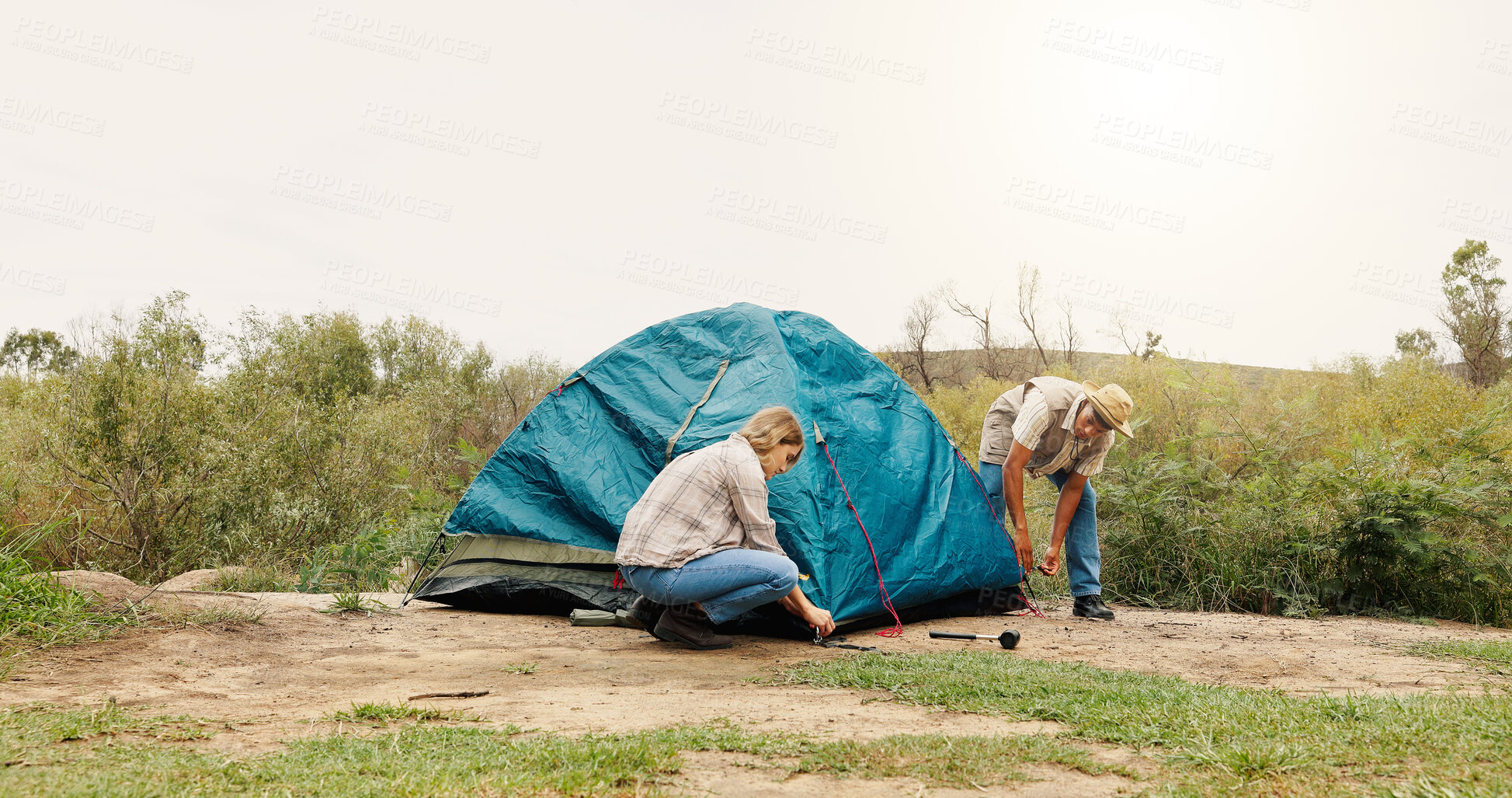 Buy stock photo Tent, help and couple with nature, teamwork and assistance with adventure, support and setting up. Camping, man or woman with preparation, cooperation or explore with recreation or vacation in Canada
