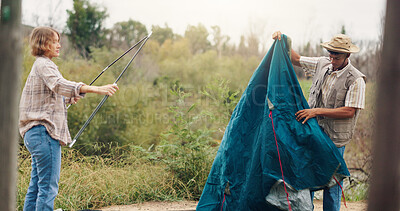Buy stock photo Couple, tent and setting camp with rods in forest for outdoor stay, adventure or travel together. Man, woman and campers with equipment or preparation for safety, shelter or protection in wilderness