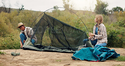 Buy stock photo Tent, help and couple with nature, support and assistance with adventure, vacation and teamwork. Camping, man and woman with preparation, setting up and talking with recreation and holiday in Canada