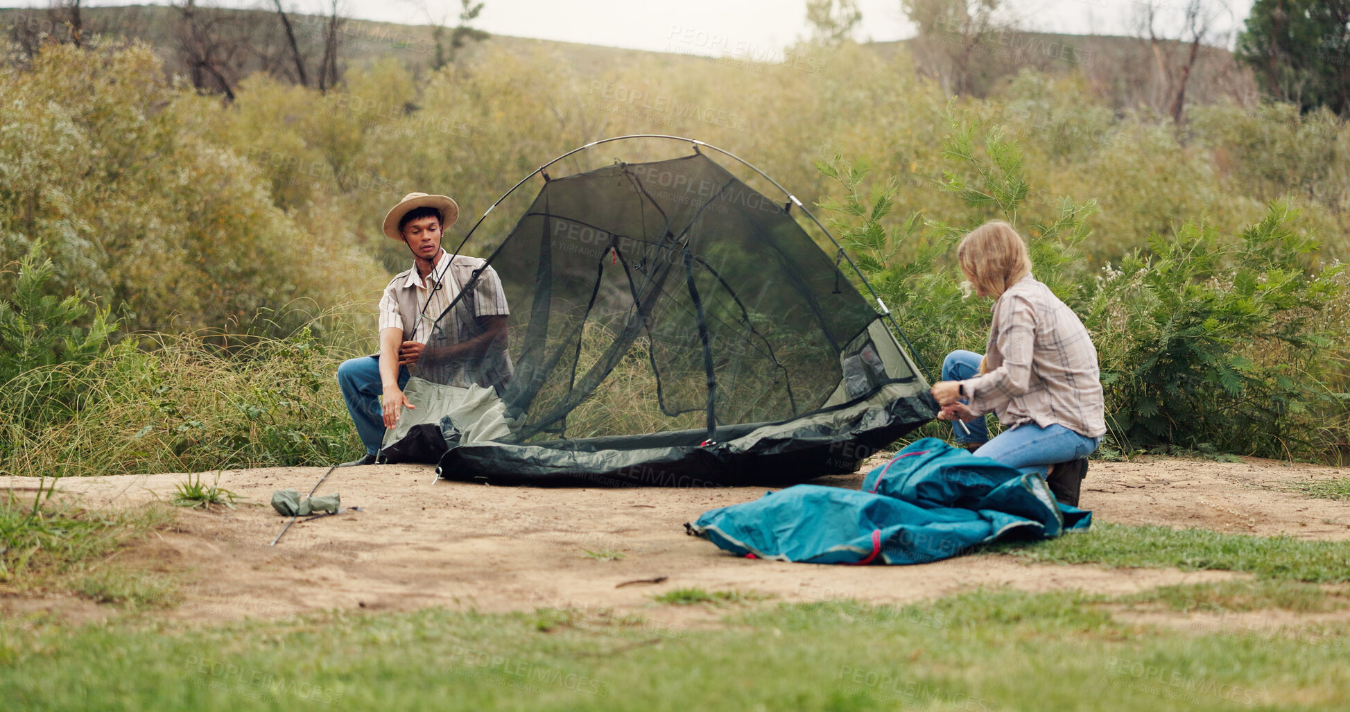 Buy stock photo Tent, help and couple with teamwork, wilderness and assistance with adventure, support and break. Camping, man and woman with preparation, setting up and nature with recreation and holiday in Canada