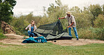 Tent, help and couple with nature, wilderness and assistance with adventure, support and teamwork. Camping, man and woman with preparation, setting up and relax with recreation and vacation in Canada