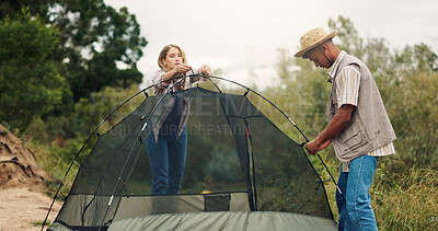 Buy stock photo Tent, help and couple with nature, camping or assistance with adventure, support or recreation. Holiday, man or woman with preparation, setting up or countryside with wilderness or teamwork in Canada