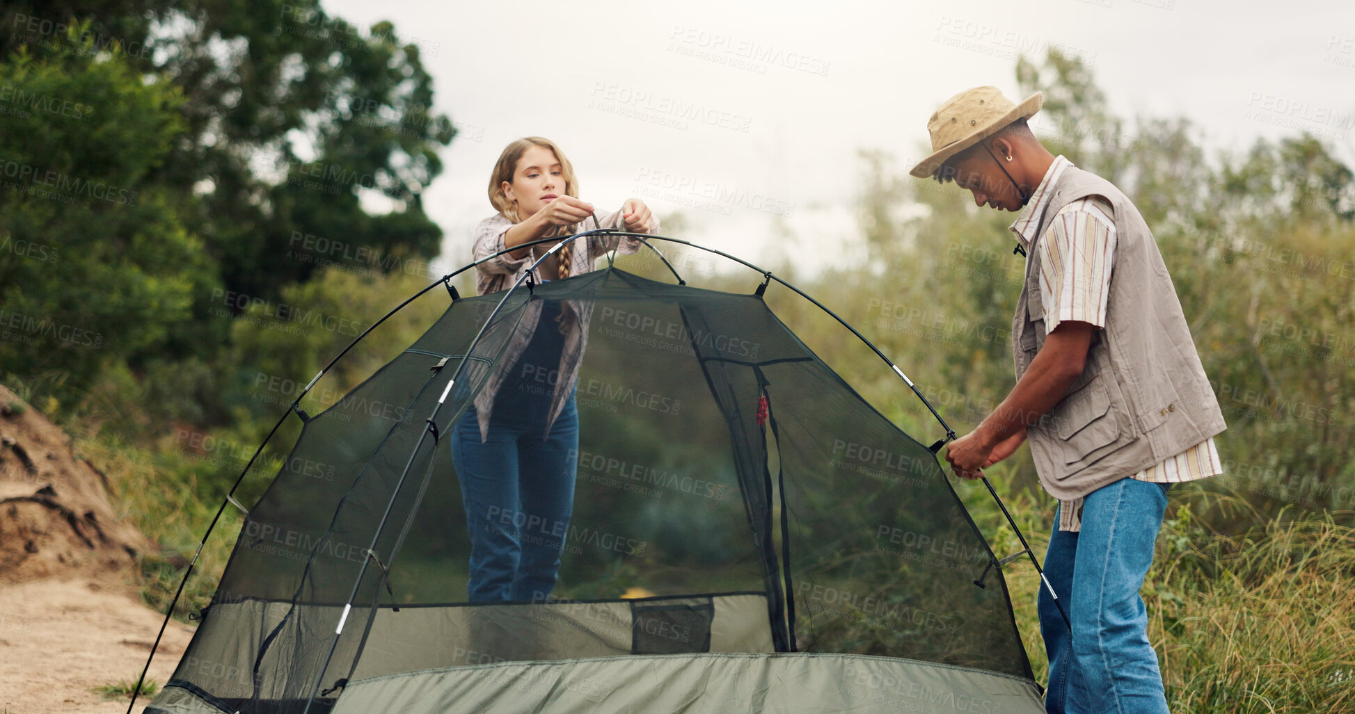 Buy stock photo Tent, help and couple with nature, camping or assistance with adventure, support or recreation. Holiday, man or woman with preparation, setting up or countryside with wilderness or teamwork in Canada
