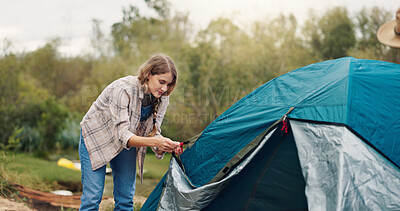 Buy stock photo Woman, camping and pitch tent in nature, gear and rope for safety on holiday adventure in summer. Girl, knot and equipment with fabric for shelter construction on vacation, tourism or getaway in bush