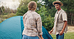 Couple, camping or forest with tent setup for outdoor stay, adventure or travel together in nature. Man, woman and campers with equipment or gear on site for safety, shelter or security in wilderness