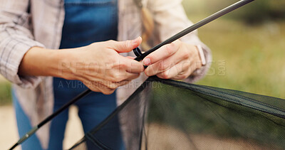 Buy stock photo Hands, person and pitching tent for camping adventure, travel preparation and holiday in wilderness. Woman, setup gear and equipment to assemble shelter, building skills and vacation safety in nature