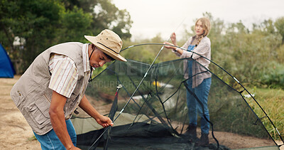 Buy stock photo Couple, building and tent for camping outdoor for travel gear, vacation adventure and bonding together. People, helping and setup equipment as nature shelter, campsite preparation and holiday getaway