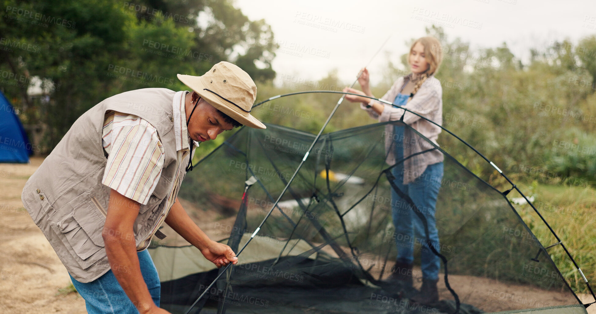 Buy stock photo Couple, building and tent for camping outdoor for travel gear, vacation adventure and bonding together. People, helping and setup equipment as nature shelter, campsite preparation and holiday getaway