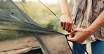 Hands, person and building tent for camping adventure, travel preparation and holiday in wilderness. Man, setup cable and equipment to assemble shelter, pitching skills and vacation safety in nature