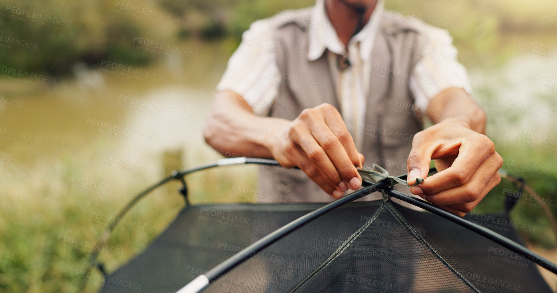 Buy stock photo Hands, man and pitching tent for camping adventure, travel preparation and holiday in wilderness. Person, tying cable and equipment to assemble shelter, survival skills and vacation safety in nature