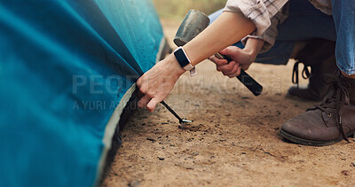 Buy stock photo Camping, hands and pitch tent with hammer for weekend shelter, holiday adventure or preparation. Woods, travel and person setting up gear at campsite for outdoor vacation, gear security or survival