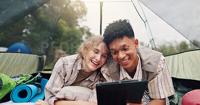 Buy stock photo Break, camping and tablet with couple in tent together for environmental conservation or research. App, relax and sustainability with happy people at campsite for bonding, ecology or love of nature