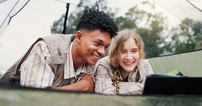 Buy stock photo Happy, couple and relax in tent with laptop for research, watching movies and bonding together. Smile, people and rest with pc on camping getaway, browsing internet and online entertainment in nature