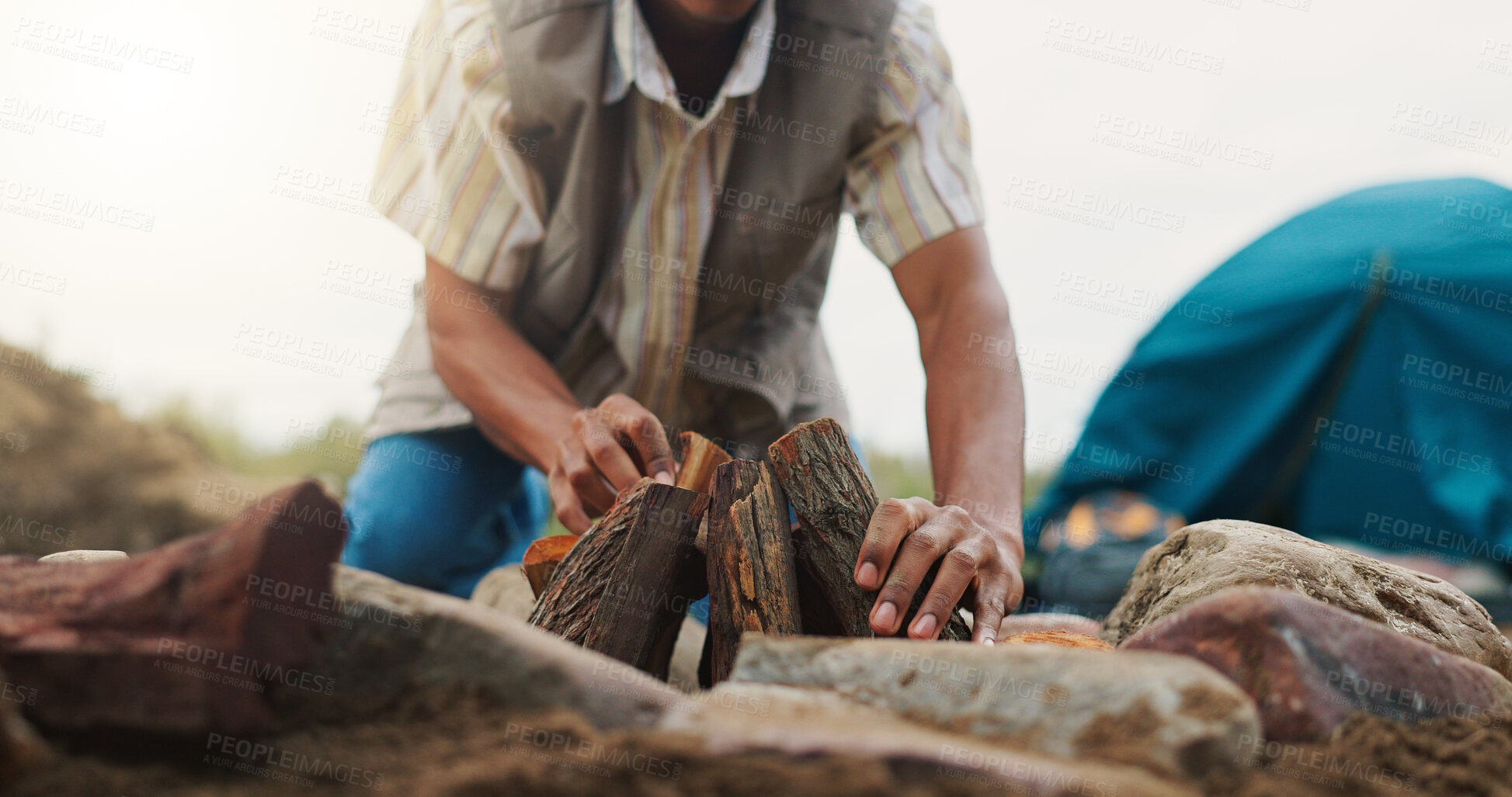 Buy stock photo Man, hands or camping with wood setup for fire preparation or outdoor campfire in nature. Closeup, male person or camper getting ready with logs or tent for survival or packing firewood in wilderness