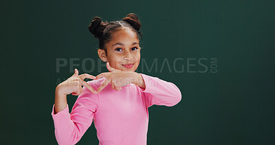 Buy stock photo Heart hands, happy and portrait of child in studio with care, kindness and support emoji. Smile, mockup space and girl kid with love hand gesture for thank you, gratitude or icon by green background.
