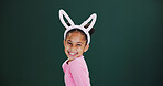 Portrait, bunny ears and girl in studio, excited and announcement on green background. Mockup space, kid and happy child with pride, promotion and Easter celebration with rabbit costume and festival