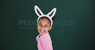 Buy stock photo Portrait, bunny ears and girl in studio, excited and announcement on green background. Mockup space, kid and happy child with pride, promotion and Easter celebration with rabbit costume and festival