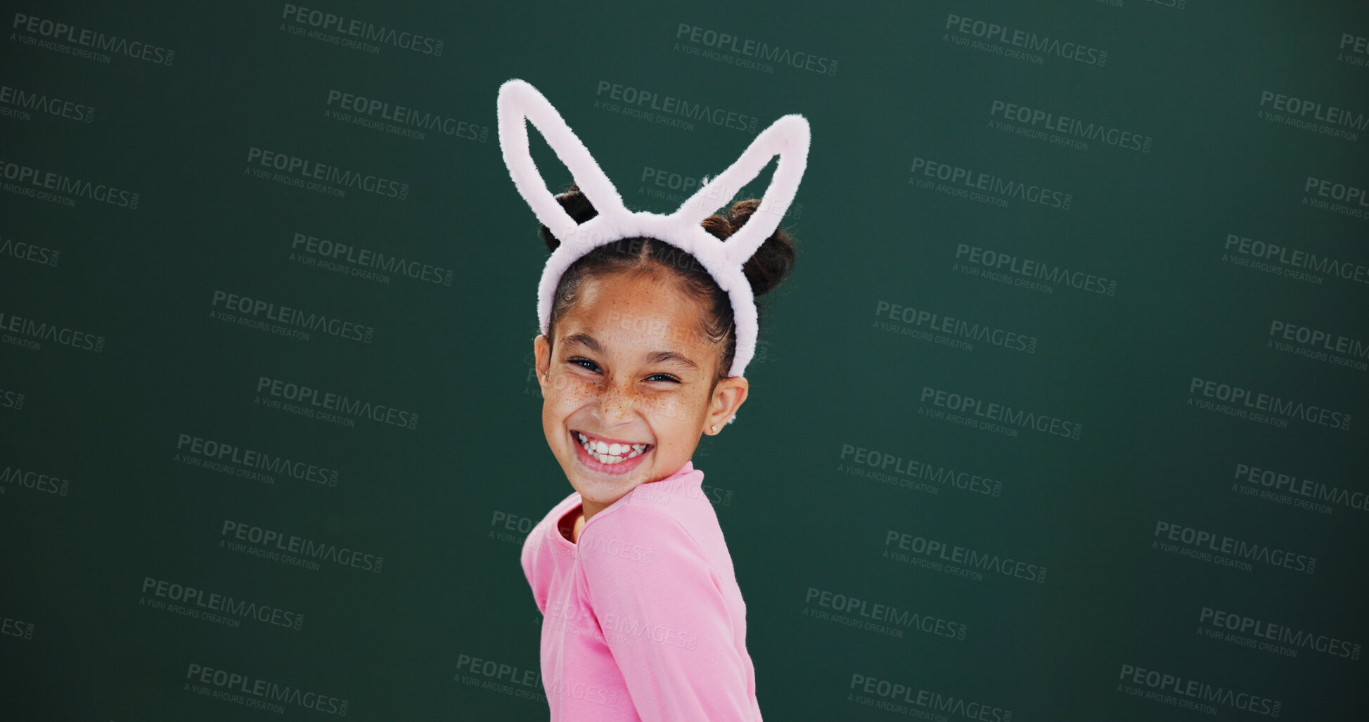 Buy stock photo Portrait, bunny ears and girl in studio, excited and announcement on green background. Mockup space, kid and happy child with pride, promotion and Easter celebration with rabbit costume and festival