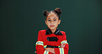 Girl, portrait and firefighter with confidence in studio for career day on a green background. Serious, child or kid with arms crossed in costume or outfit for help, safety or rescue on mockup space