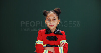 Buy stock photo Girl, portrait and firefighter with confidence in studio for career day on a green background. Serious, child or kid with arms crossed in costume or outfit for help, safety or rescue on mockup space