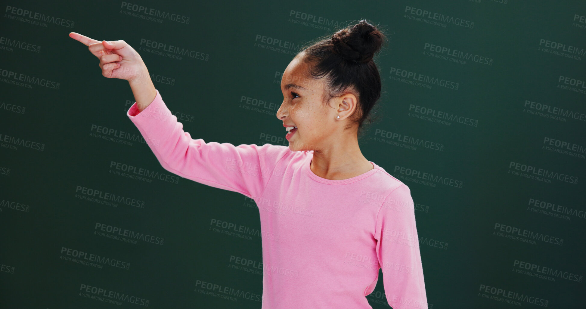 Buy stock photo Studio, news and child with smile, pointing and happy for presentation, announcement or mockup space. Green background, advertising and girl with positive attitude for offer alert, deal and promotion
