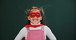 Portrait, superhero and girl in studio, smile and Halloween costume on green background. Happiness, wind and child with fantasy, scifi and comic with character, fun and games with cosplay and excited