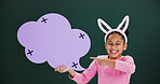 Portrait, pointing and girl with speech bubble, excited and announcement on green studio background. Happy kid, child development and cloud space with card, promotion and poster for prize giveaway