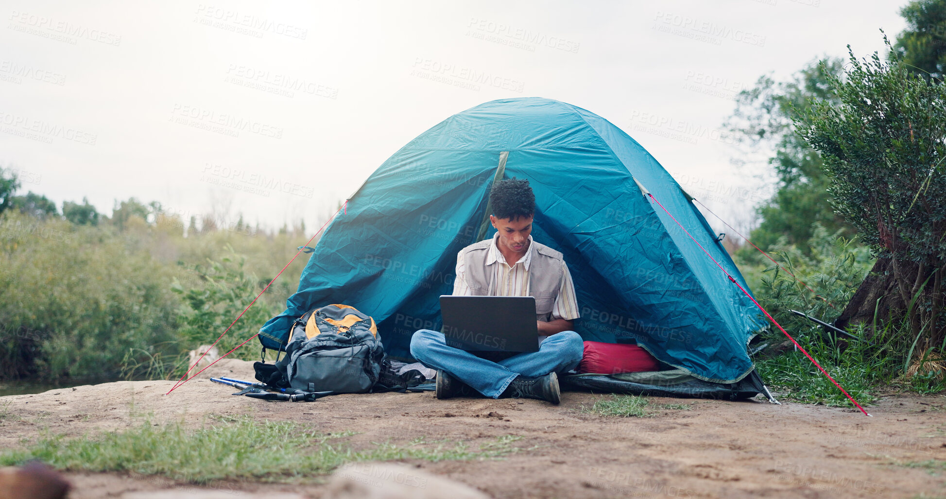 Buy stock photo Nature, camping and man with laptop, tent and travel writer on holiday, remote work or search on web. Online, author and person with tech for article, freelancer and vacation in forest and outdoor