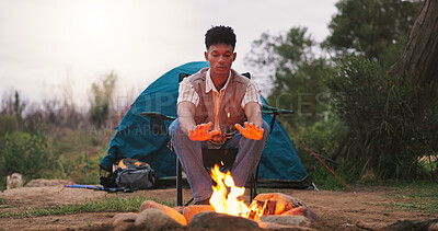 Buy stock photo Camping, man and relax by fire in woods for heating hands, freedom and travel adventure. Countryside trip, peaceful and person with campfire for vacation warmth, eco friendly holiday or weekend break