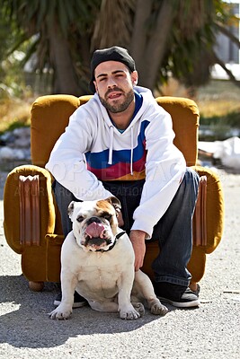 Buy stock photo Couch, city and portrait of man with dog in street for urban fashion, casual style and trendy outfit. Hip hop, pets and person on sofa in road with canine, bulldog and best friend for relaxing
