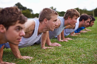 Buy stock photo Group, men and field for push up with exercise, training and health with friends for sport, challenge or wellness. People, athlete and teamwork with fitness, workout and together on grass for muscle