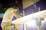 Artisan, tools  and person in workshop with surfboard, repair and working in industry. Production, startup and man in manufacturing with equipment, polish and smoothing for hand made product.