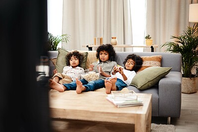 Buy stock photo Relax, children and eating popcorn on sofa in lounge, tv or bonding by streaming movie for entertainment on holiday. Boy, family and snack food together for video subscription with childhood film