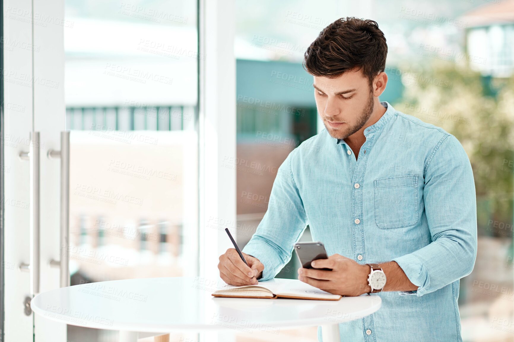 Buy stock photo Business man, writing and notebook with phone in office for contact, deal and search for info at startup. Person, writer or editor with smartphone, mobile and review for project at creative agency