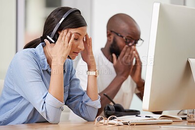 Buy stock photo Colleagues, call centre and headset with headache, stress and customer support at desk. Migraine, computer or toxic work environment or burnout, telemarketing or medical problem for business employee