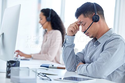 Buy stock photo Tired, headache and businessman with headset in office for career, call agent or telecommunication. Employee, male person or consultant for advice, support or answer questions for customer service