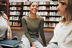 Student, friends and book discussion in library with smile for education, learning or knowledge at university. Group of happy women enjoy conversation, book club or social study for research project