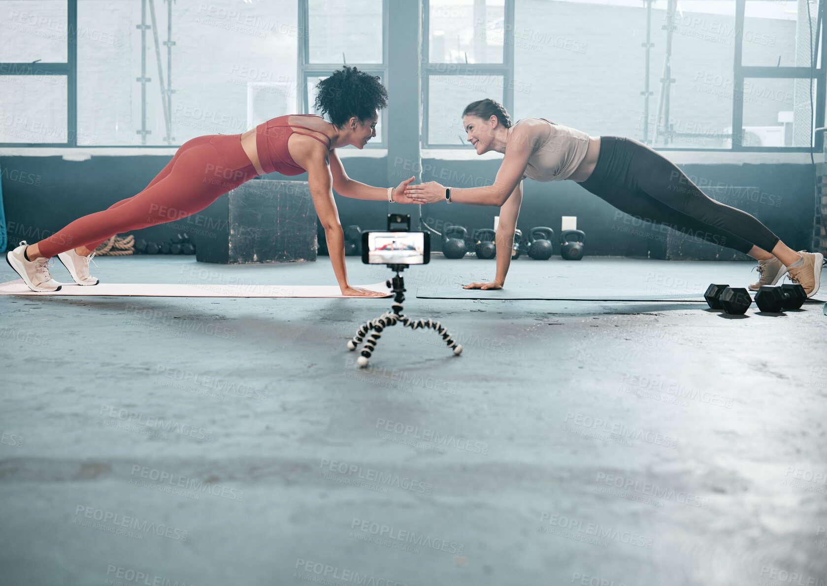 Buy stock photo Influencer workout, phone and people recording, filming or broadcast online training video, fitness tutorial or guide. Sports, handshake and athlete team, women of friends live streaming gym exercise