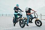 Mature couple, electrical or checking bike by beach in bonding transportation, clean energy or sustainability city travel. Ebike, electricity or eco friendly bicycle for elderly man or cycling woman