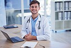 Man, doctor and portrait smile with laptop for healthcare, Telehealth or research at office desk. Happy male medical professional smiling by computer for medicare innovation or development at clinic