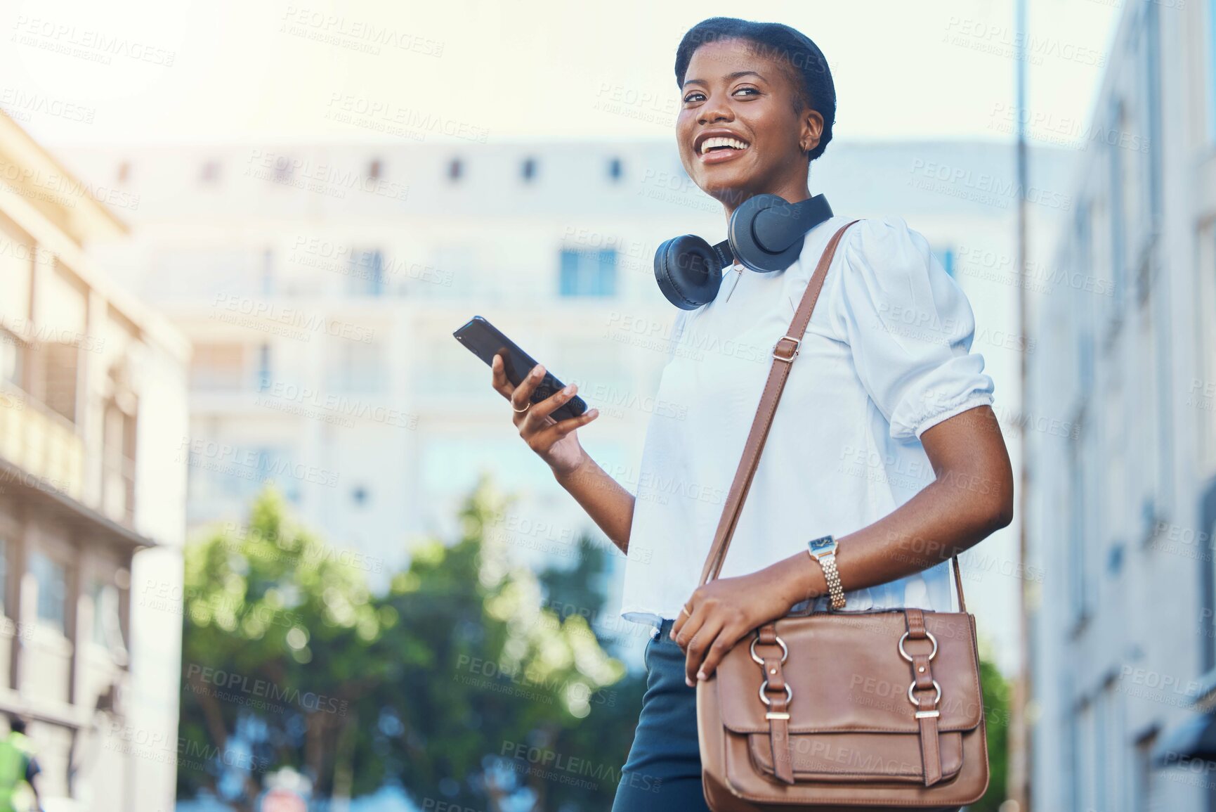Buy stock photo Phone, walking and young woman in the city networking on social media, mobile app or the internet. Happy, technology and African female person scroll on cellphone and commuting in urban town street.
