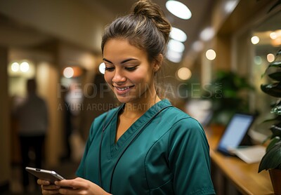 Buy stock photo Happy young nurse posing in hospital reception. Phone in hand. Medical concept.